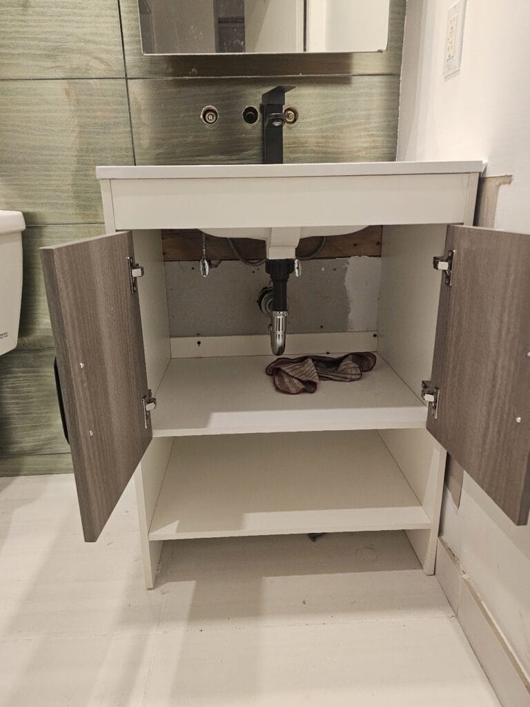Sink drain and trap connected under the new vanity