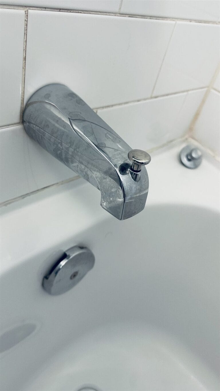 Chrome tub spout with diverter above the bathtub