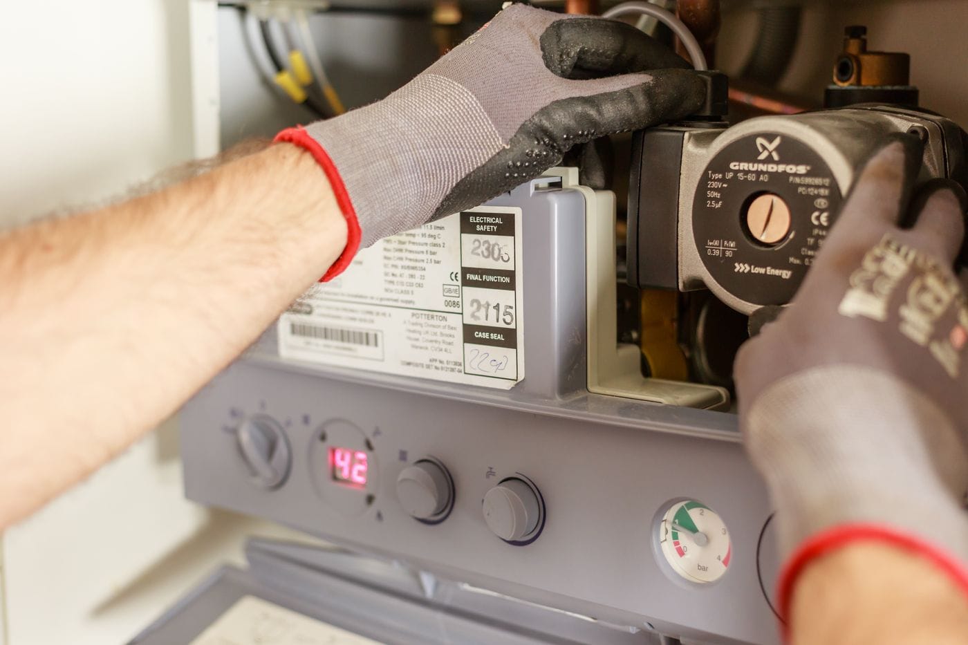 A technician servicing a boiler and heating system