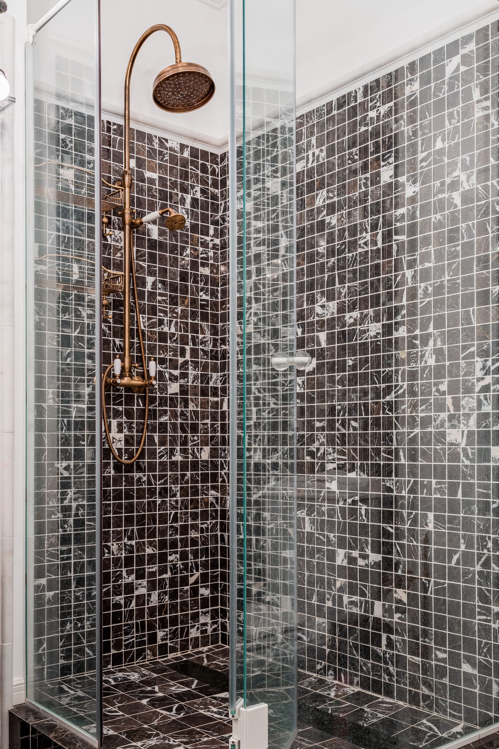 Custom shower with rain head and hand shower on tile