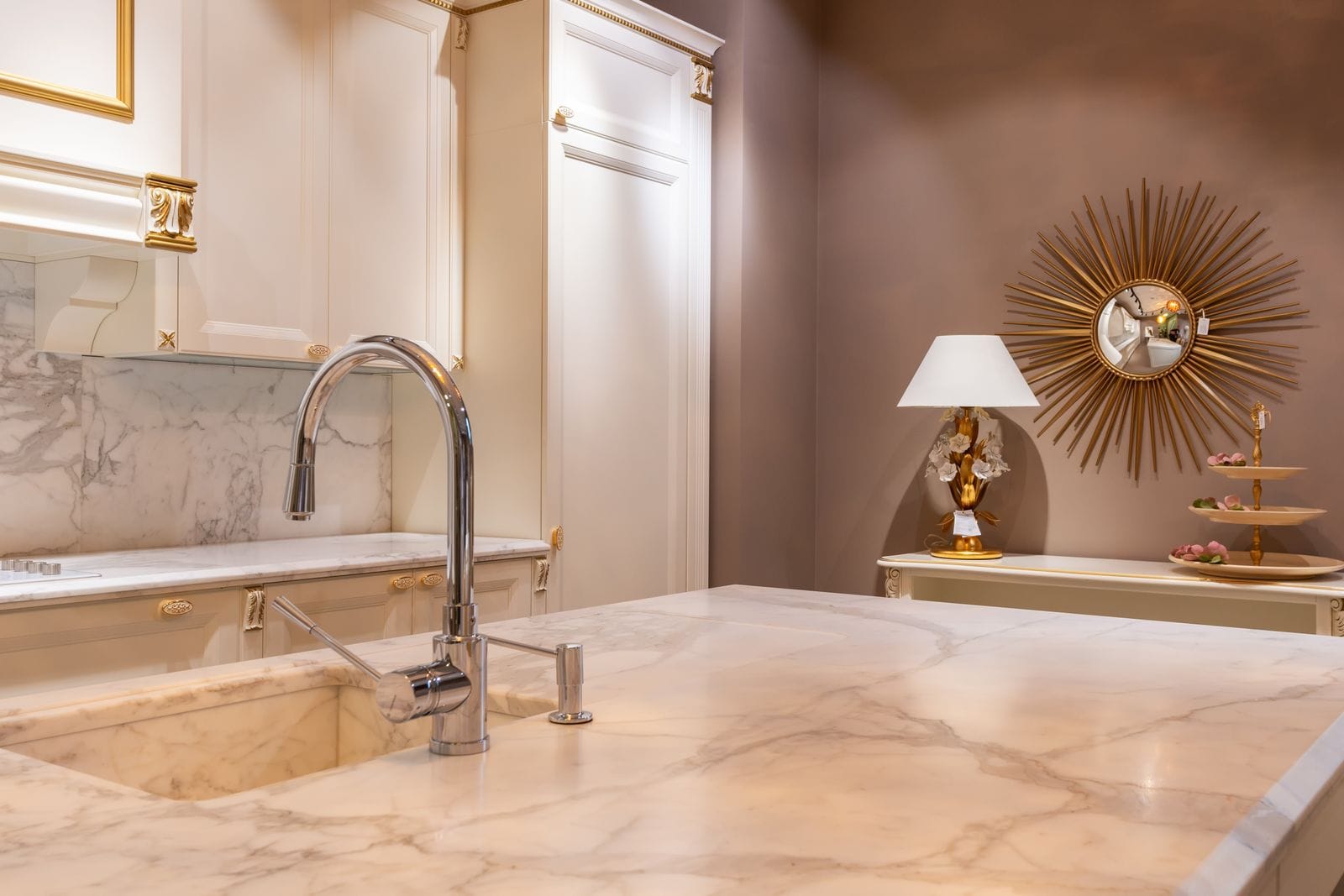 Luxury kitchen with a marble counter and gooseneck faucet