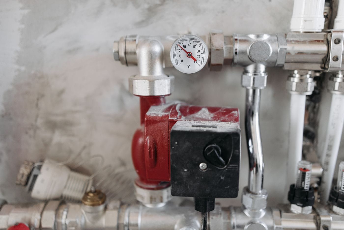 Steel water pipes with a pressure gauge in a utility room