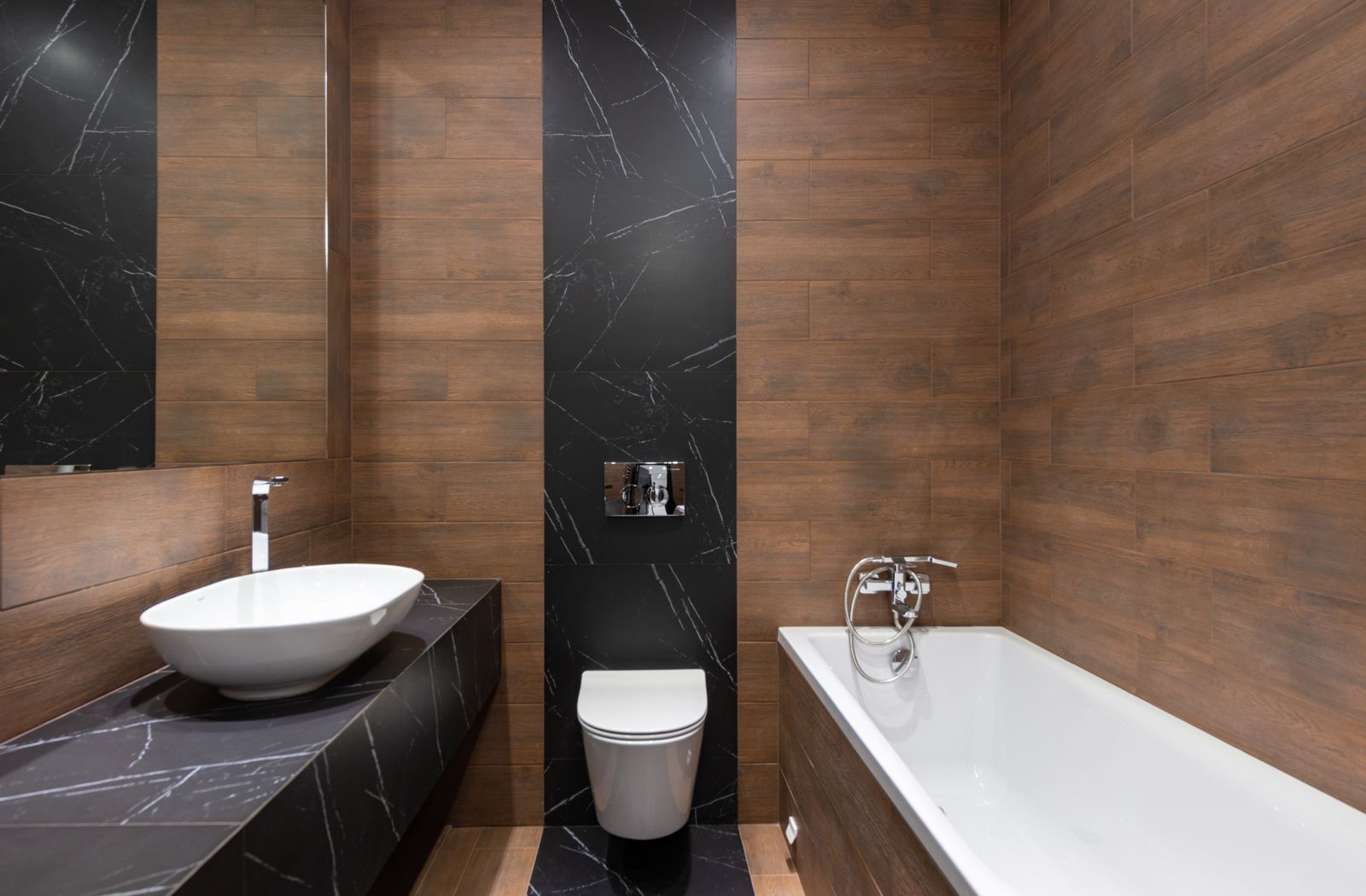 Ensuite with wood and marble walls, a vessel basin and a wall-hung toilet